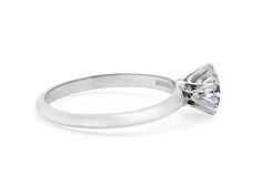 a white gold ring with a princess cut diamond