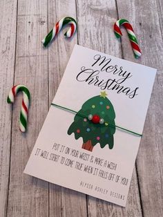 a christmas greeting card with candy canes on the side and an envelope for it