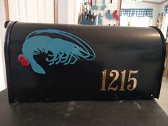 a black mailbox with a blue lobster on it