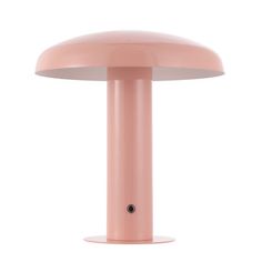 a pink table lamp sitting on top of a white surface