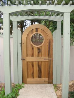 a wooden gate with a circular window on it