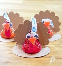 three turkey shaped candy bags sitting on top of a wooden table