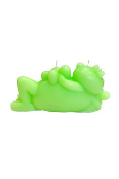 a green candle that is shaped to look like a frog laying on it's back