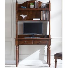 a desk with a computer on top of it and bookshelf above the desk