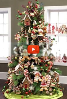 a christmas tree decorated with gingerbreads and candy canes is featured in this video