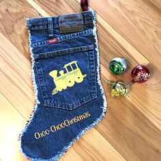 an old pair of jeans has been decorated with a construction truck christmas stocking and ornaments