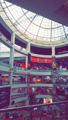 the inside of a shopping mall filled with people