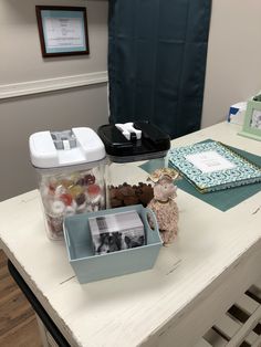 an office desk with various items on it and pictures in the bins next to them