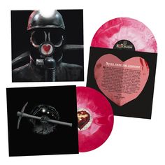 two pink vinyl records, one with an image of a man in gas mask and the other with a heart