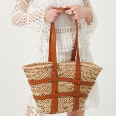 Kensie Straw Basket Shopper. Popular straw basket with criss-cross harness style faux leather straps details. A great new style basket bag for summer outings and more. Size:Top L47cm x Bottom L24cm x H27cm x W14cmThe handle height 34cm Gender: WOMENItem Type: Shoulder & HandbagsMain Material: StrawClosure Type: STRINGHardness: HARDLining Material: polyesterNumber of Handles/Straps: TwoInterior: No PocketDecoration: Criss-Cross Harness Style, Straw Beach Tote, Straw Basket, Straw Tote Bag, Straw Handbags, Leather Patchwork, Rattan Bag, Khaki Fashion, Woven Tote Bag