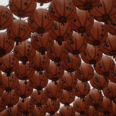 many chinese lanterns are hanging in the air