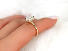 a woman's hand with a diamond ring on it