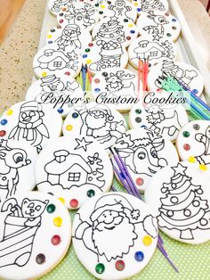 some decorated cookies on a table with markers