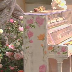 a white piano with pink flowers on it