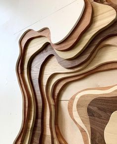 several wood pieces are arranged in the shape of wavy lines on a white background,