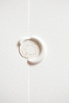 a white object with a circular hole in the middle