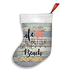 a christmas stocking that says life is better at the beach