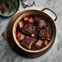 a pot filled with stew sitting on top of a table