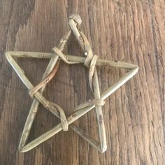 an ornament made out of sticks on a wooden table