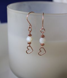 "Dainty handcrafted rose gold 14k filled heart earrings with natural 18k rose gold 4x2mm rondelle hematite and natural white 6mm laser diamond cut iridescent mother of pearl gemstone. These heart drop earrings are simple, delicate, modern and can be worn ever day and/or to gift as a thank you. Mother of Pearl is a gemstone that has a meaning and properties of being generous.  Mother of pearl is an organic gemstone and refers to the iridescent lining that's found in the inner surface of a nacre-p Mothers Day Earrings, Cute Handmade Heart Earrings For Gift, Dainty Handmade Heart Earrings, Handmade Cute Heart Drop Earrings, Elegant Gold Handmade Heart Earrings, Home Made Earrings, Mother's Day Heart-shaped Earrings With Ear Wire, Handmade Jewelry Earrings, Mother Of Pearl Earrings