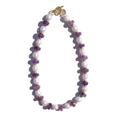 Yareia Necklace in Amethyst and Natural Pearls The Yareia Necklace is a refined composition of rich amethyst, lustrous freshwater pearls, and delicate gold-flecked accents. Featuring alternating beads of deep purple amethyst discs and radiant natural water pearls, each section is punctuated by gold-flecked spacers that add a touch of warmth and elegance. Completed with a handcrafted Marne clasp, this necklace is both timeless and striking. Key Features:- Amethyst disc beads with deep, vibrant pu Healing Goddess, Amethyst Stones, Forever Jewelry, Jewelry Ring Box, Water Pearls, Stone Gold, Men's Jewelry Rings, Amethyst Necklace, Purple Hues