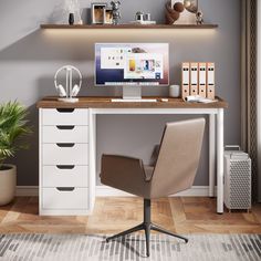 a desk with a computer on top of it and a chair in front of it