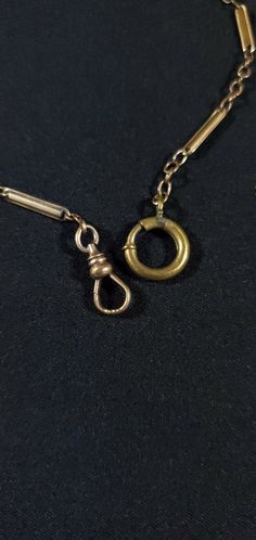 Offered is an outstanding and unique pocket watch chain fob circa 1880's. The chain measure, from end-to-end, 10 inches and is gold filled. The links are strong and attractive! The end hook and swivel are strong and mechanically sound and will securely hold your time piece or locket for many years to come. This item has a lovely coat or patina that took over 130 years to form. Many people appreciate their antique jewelry with this lovely coating (myself included); however, some prefer a shinier Vintage Engraved Chain Link Necklace, Gold Antique Brass Pocket Watch, Vintage Gold Necklace With Hook And Links, Vintage Gold Necklace With Hooks And Links, Antique Engraved Chain Link Necklace, Antique Gold Brass Pocket Watch, Victorian Gold Jewelry With Hooks And Links, Antique Bronze Chain Jewelry, Gold Engraved Steampunk Pocket Watch