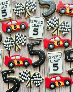 decorated cookies with race cars and numbers are on a wooden table next to each other