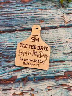 a wooden tag that says tag the date and is attached to a piece of wood