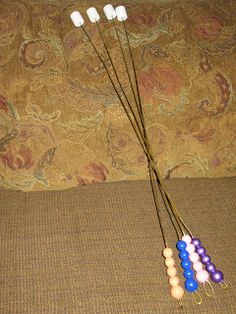 four different colored beads hang from a cord on a couch