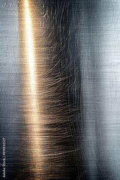 an abstract metal background with lots of shiny silver and gold streaks on the top of it