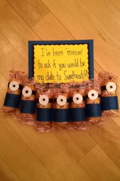 a bunch of rolls sitting on top of a wooden floor next to a sign that says, i've been minor to ask if you would be my don't want to sweethearts?