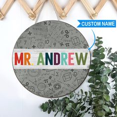 a wooden sign with the word mr andrew on it next to a potted plant