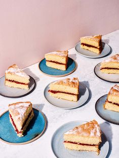 several slices of cake are on blue plates