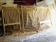 two wooden beds sitting on top of a sheet covered floor