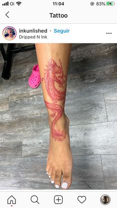 a woman's foot with a dragon tattoo on it