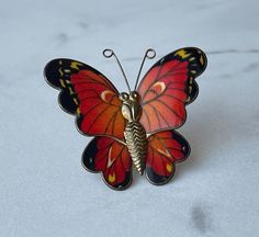 Vintage Gold Tone and Enamel Butterfly Brooch Pin Colorful butterfly enameled with reds, orange, yellow and black. Measures appropriately 1 3/4" x 1 1/2". Weight: 4.5 grams. In great vintage condition! Butterfly-shaped Enamel Pin Gift, Vintage Handmade Butterfly Brooch, Butterfly Shaped Enamel Pin For Gifts, Handmade Vintage Butterfly Brooch, Red Enamel Vintage Brooch, Vintage Red Enamel Brooches, Enamel Butterfly, Colorful Butterfly, Butterfly Brooch