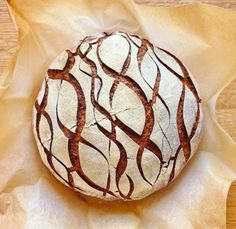 a round bread sitting on top of a piece of paper