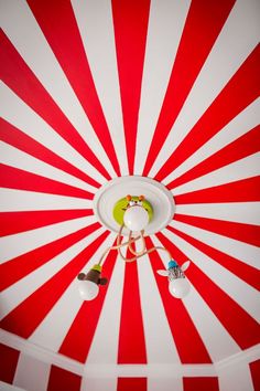 an overhead view of a ceiling with red and white stripes on the ceiling, including two lights