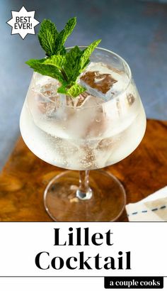 a cocktail in a glass with ice and mint