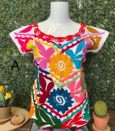 Casual Tops With Multicolor Embroidery And Patchwork, Colorful Short Sleeve Cotton Blouse, Traditional Cotton Tops With Contrast Embroidery, Spring Embroidered Top With Geometric Multicolor Embroidery, Summer Multicolor Embroidered Top With Embroidered Neckline, Fitted Multicolor Tops With Floral Embroidery, Fitted Multicolor Floral Embroidered Top, Fitted Multicolor Top With Floral Embroidery, Traditional Multicolor Embroidered Blouse