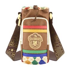 a brown bag with multicolored straps and an emblem on the front