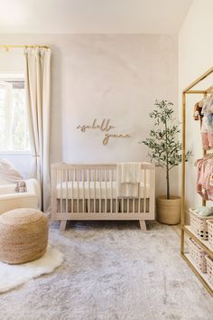 a baby's room with a crib, chair and rug