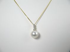 This South Sea Pearl Pendant made of a single 10-11mm Cultured White South Sea pearl with Silverly overtone and warm luster. Set on 18KT yellow gold setting containing 3 round cut diamonds in total weight of 0.1767 carats. (Average color/clarity: G/VS2). 14KTY gold chain are available for purchase. A pearl is a gift from nature, an art work with natural beauty.The white South Sea pearl reaches the height of its perfection when it is taken from the shell. It is as complete and perfect in its own way as an exquisite art work. SOUTH SEA PEARLS are grown in large tropical or semi-tropical oysters in Australia, Myanmar, Indonesia and other Pacific countries. These generally range in size from 10mm to 20mm and command premium prices because of their relative rarity and large size. Classic Round Brilliant Cut Pearl Necklace, Yellow Gold Pearl Jewelry With Brilliant Cut, Yellow Gold Pearl Jewelry, Classic Round Pearl Necklace With Diamond Accents, Classic Akoya Pearl Necklace With Brilliant Cut, Elegant High Luster Round Cut Jewelry, Elegant Akoya Pearl Necklace With Brilliant Cut, Yellow Gold Pearl Necklace With Diamond Accents, Saltwater Pearls