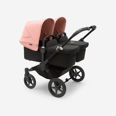 two strollers, one in pink and the other in black on a white background