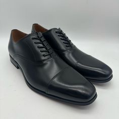 Elevate Your Style With These Sleek Florsheim Carino Cap Toe Oxford Black Dress Shoes In Men Size 11 D. The Shoes Feature A Solid Pattern And A Black Color That Exudes Sophistication, Making Them Perfect For Formal Occasions. Made With High-Quality Leather Materials, Both The Lining And Upper Materials Are Durable And Comfortable To Wear. The Shoes Also Boast A Synthetic Outsole That Provides Excellent Traction And Stability, And A Cap Toe Design That Adds A Touch Of Elegance. These Dress Shoes Fitted Snip Toe Oxfords For Business Casual, Black Fitted Dress Shoes With Round Toe, Fitted Black Dress Shoes With Round Toe, Fitted Black Dress Shoes, Fitted Black Snip Toe Leather Shoes, Fitted Black Leather Shoes With Snip Toe, Black Cap Toe Dress Shoes For Semi-formal Occasions, Black Cap Toe Dress Shoes For Business Casual, Black Fitted Almond Toe Dress Shoes