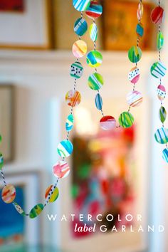 colorful glass beads hang from a string on a table