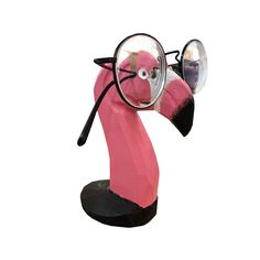 a pink flamingo wearing glasses and holding a magnifying glass in its beak