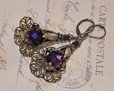 "Beautifully detailed earrings metallic purple crystal teardrops, topped with metallic purple bicone crystals and bronze filigree bead caps and findings.  Nickel- and lead free antique bronze lever back brass earrings. These beauties measure approximately 42mm (1,7\") from the lower part of the hook. A romantic pair of vintage style earrings full of whimsical charm and timeless beauty! If you have any questions just convo me and I will get back to you as soon as possible. Thanks for looking // Mari" Fairy Earrings, Gothic Fairy, Earrings Art, Vintage Style Earrings, Purple Crystal, Purple Crystals, Brass Earrings, Style Earrings, Bead Caps