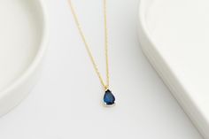 This elegant Crystal Sapphire Necklace is a perfect gift choice, combining simplicity with sophistication. Ideal as a birthday gift, this Dainty Necklace makes a thoughtful present for moms, loved ones, or even a treat for yourself. The intricate craftsmanship highlights the dazzling blue of the sapphire stone, while the gold-filled chain adds a touch of refined elegance. This Gold Necklace comes beautifully packaged, ready to be gifted for any special occasion. With its delicate chain and small sapphire stone, this necklace is easy to wear in any setting. For those who appreciate blue-toned gems like the Blue Topaz Pendant, this piece offers both silver and gold options to suit different tastes. Its minimal, dainty design makes it perfect for layering with other necklaces. The subtle, eye Minimalist Sapphire Necklace For Gifting, Blue Dainty Gemstone Necklace, Dainty Sapphire Birthstone Necklace, Elegant Faceted Sapphire Necklace, Dainty Blue Faceted Necklace, Tiny Necklace, Blue Sapphire Necklace, Minimal Color, Blue Topaz Pendant